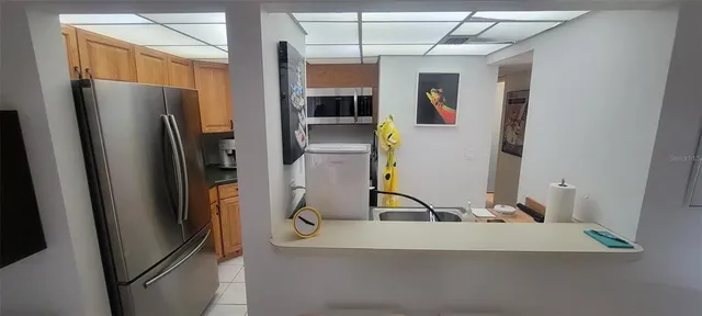 a view of a refrigerator in kitchen
