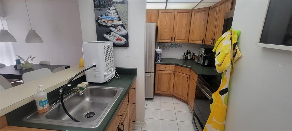 160 Live Oak Woods Court, Unit 3C Deltona, FL 32725 - Photo 5 of 19 a utility room with a sink a washer and dryer