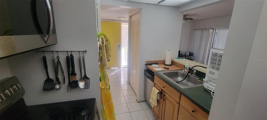 160 Live Oak Woods Court, Unit 3C Deltona, FL 32725 - Photo 6 of 19 a kitchen with a stove and a refrigerator