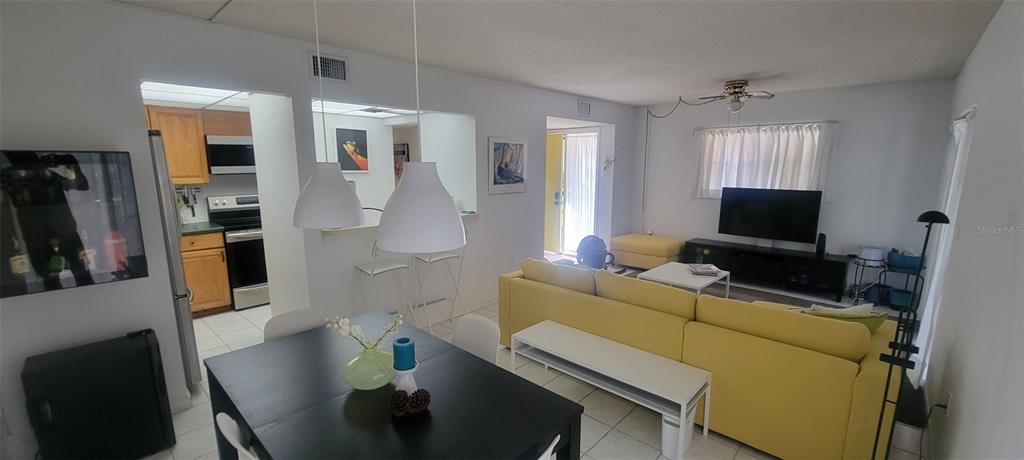 160 Live Oak Woods Court, Unit 3C Deltona, FL 32725 - Photo 9 of 19 a living room with furniture and a flat screen tv