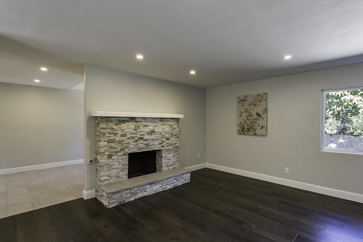 1 Little Creek Road Soquel, CA 95073 - Photo 5 of 21 an empty room with wooden floor a fireplace and windows