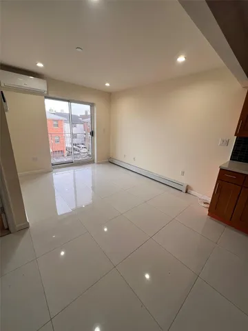 a view of a livingroom with an empty space and a window
