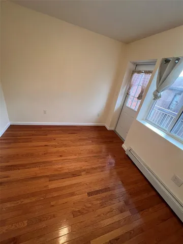 a view of an empty room and wooden floor