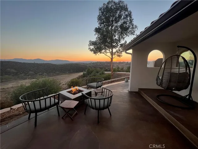 a kitchen with stainless steel appliances a sink a stove a refrigerator cabinets and chairs