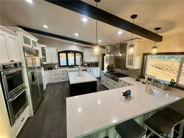 a room with pool table and paintings on the wall