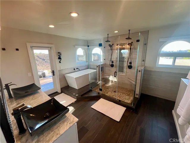 a view of a hallway with entryway wooden floor and front door