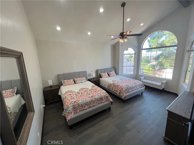 a view of a room with wooden floor and furniture