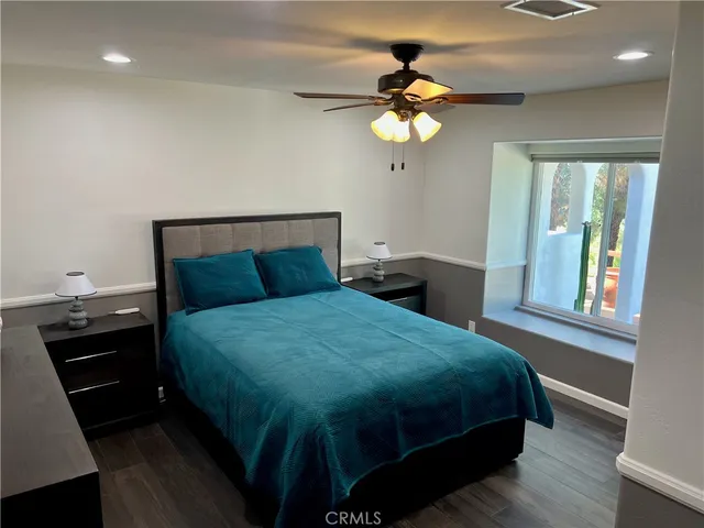 a bed sitting in a bedroom next to a window