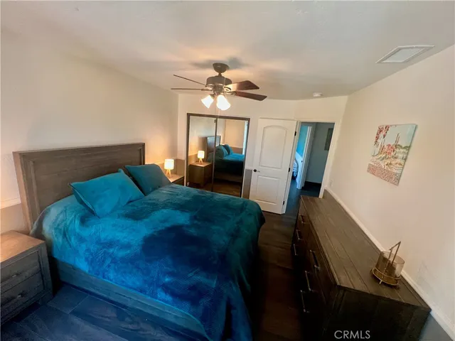 a bedroom with a bed table and window