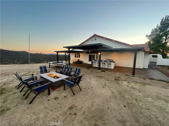 a view of a porch with a table chairs and wooden fence