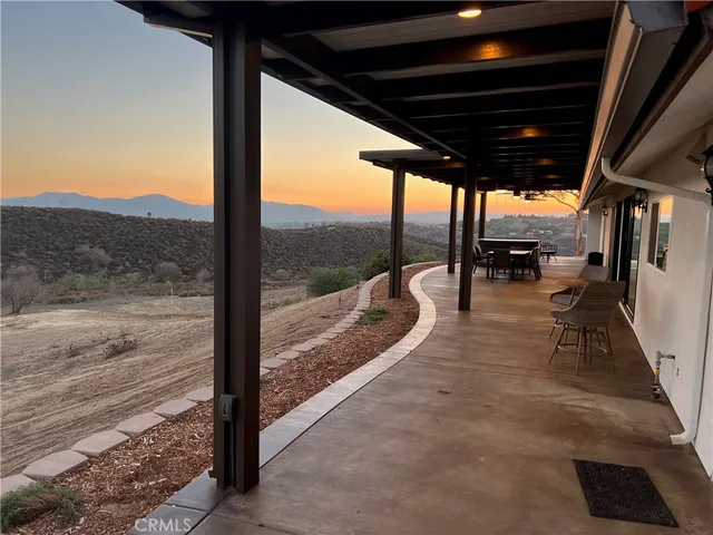 a living room with furniture and large windows
