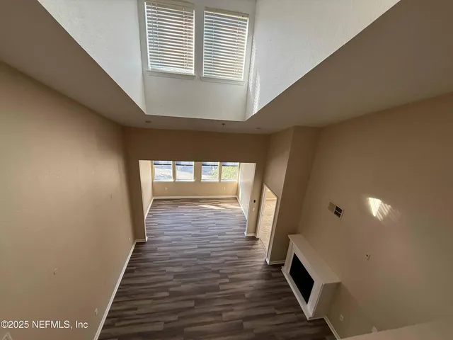 a view of hallway with wooden floor