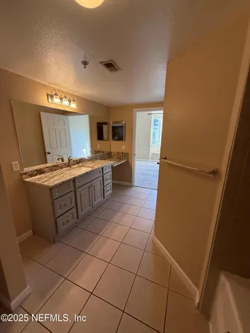 a kitchen with a sink a stove top oven and cabinets