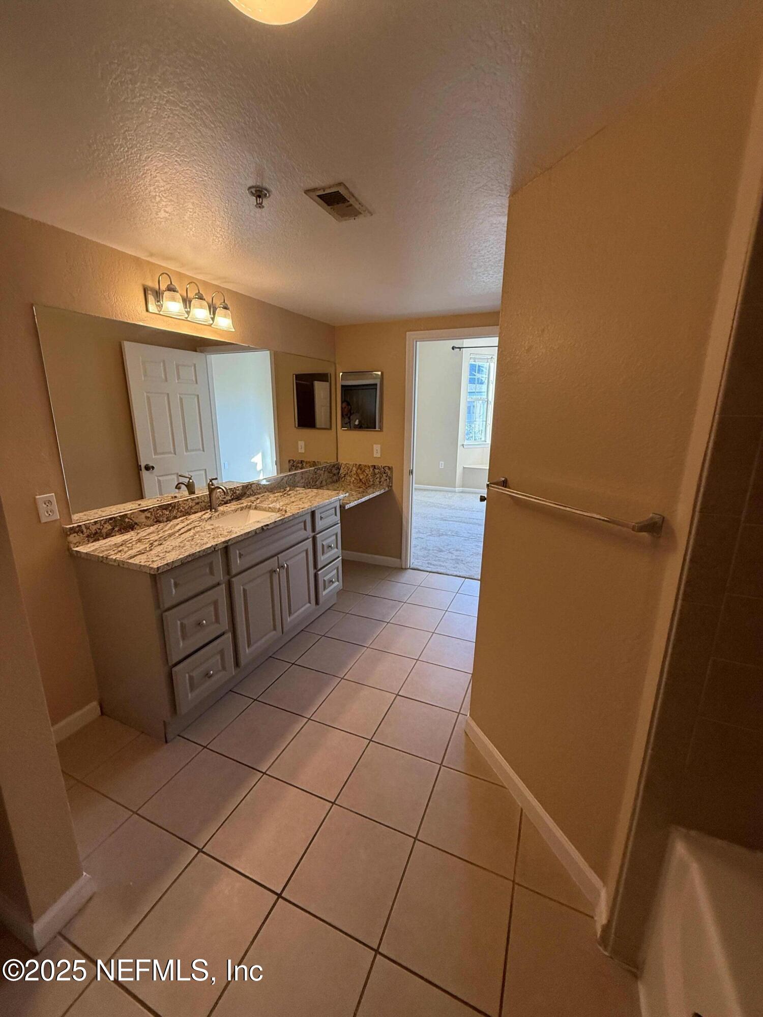 8550 Touchton Road, Unit 1633 Jacksonville, FL 32216 - Photo 15 of 21 a kitchen with a sink a stove top oven and cabinets
