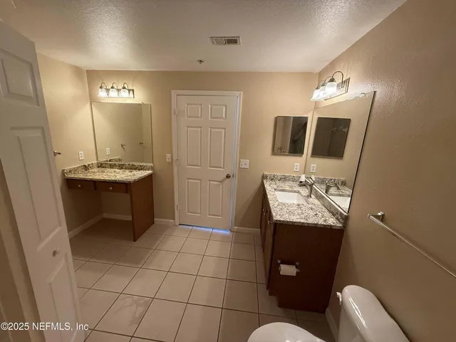 a bathroom with a sink toilet and mirror