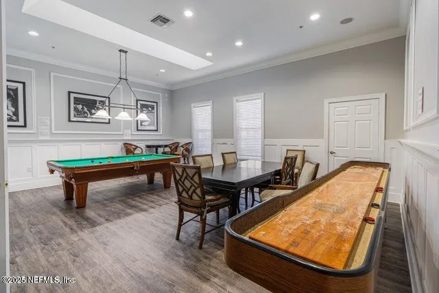 a room with furniture pool table and window