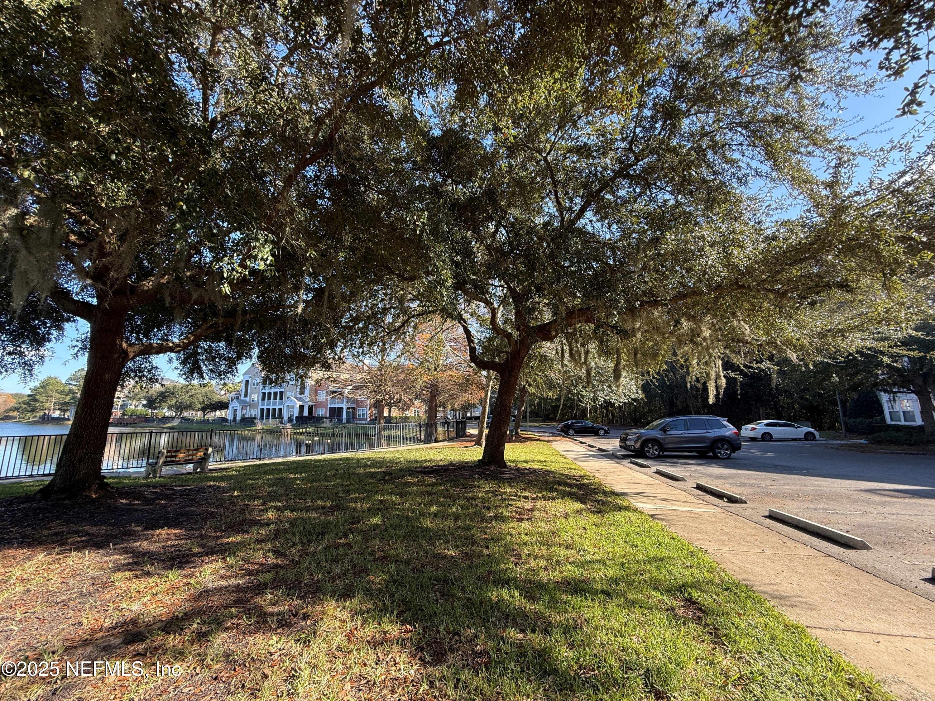 8550 Touchton Road, Unit 1633 Jacksonville, FL 32216 - Photo 8 of 21 a view of swimming pool with lawn chairs and trees