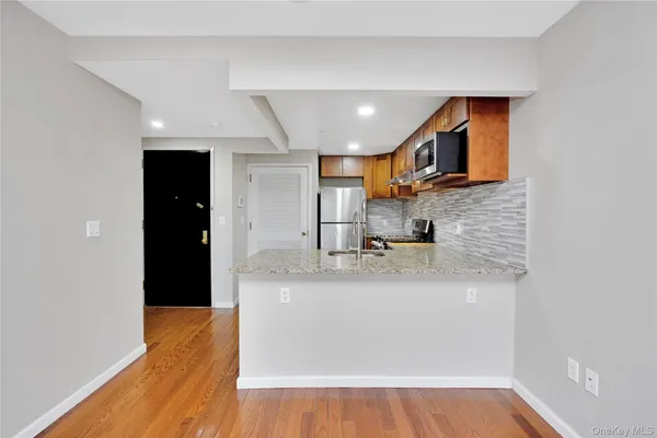 a kitchen with stainless steel appliances granite countertop a sink and a granite counter top