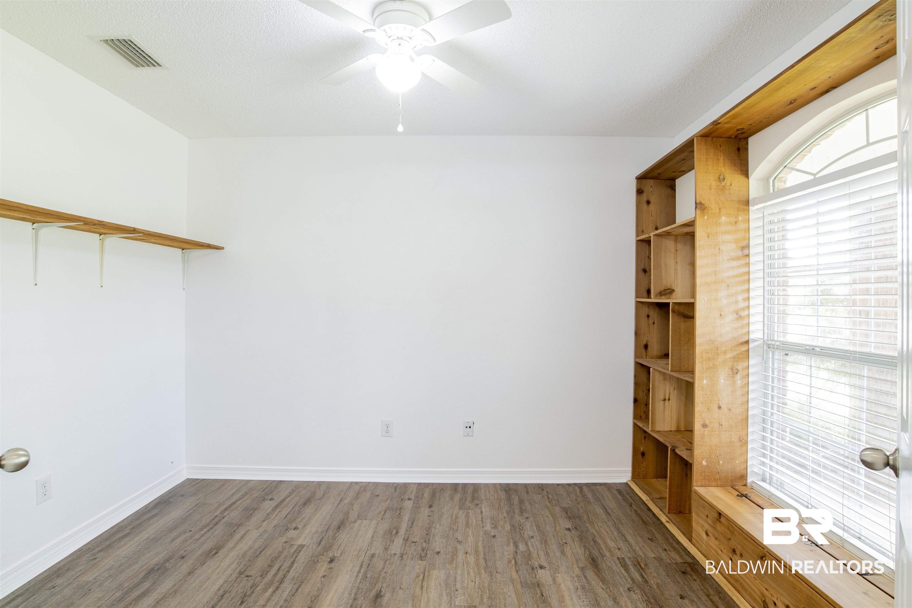 165 Pemberton Loop Fairhope, AL 36532 - Photo 7 of 25 Empty room with a ceiling fan, wood finished floors, baseboards, and visible vents