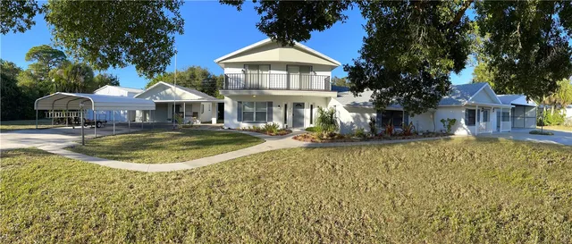 a view of a house with swimming pool and sitting area