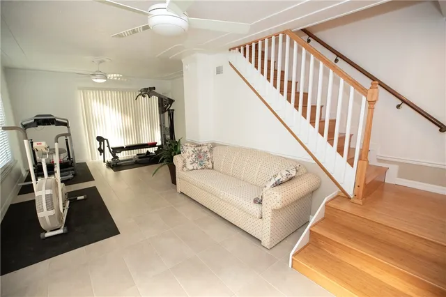 a living room with furniture gym equipment and a view of living room