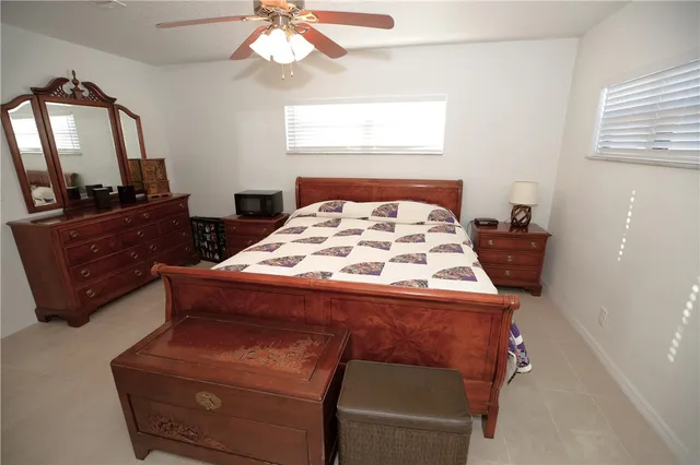 a bedroom with a bed and a mirror on the dresser