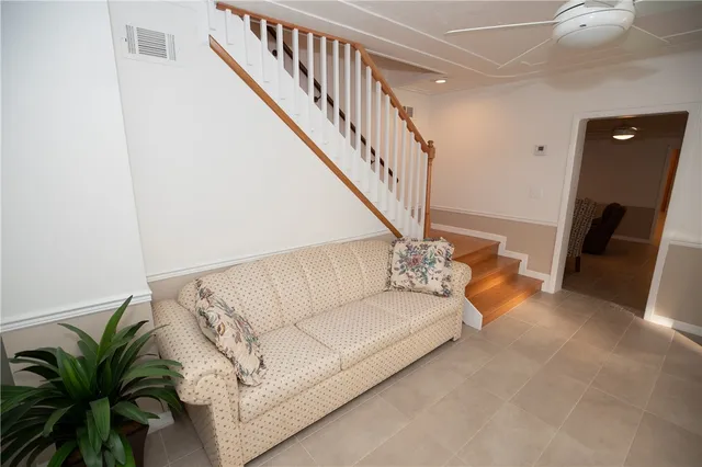a living room with furniture and stairs