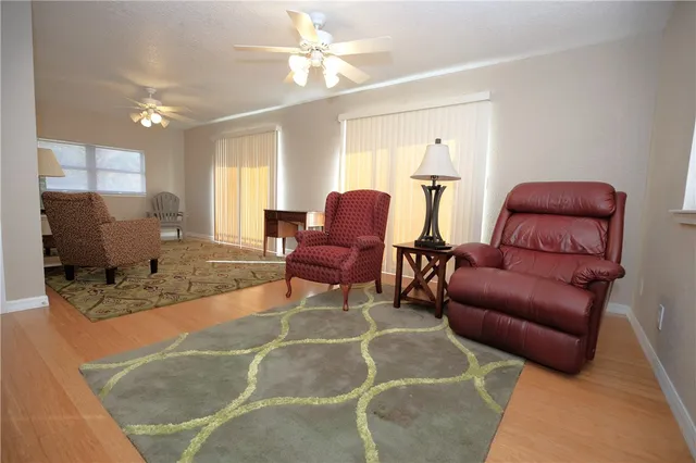a living room with furniture a fireplace and a window