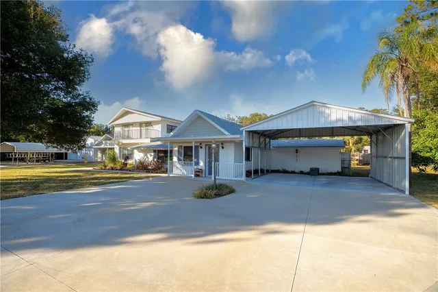 a view of a house with swimming pool and sitting area