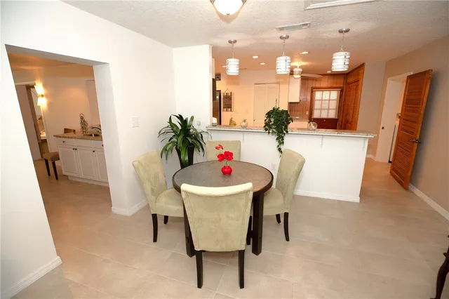 a dining room with furniture and a chandelier