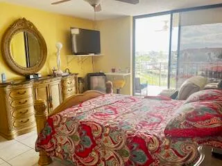 a bedroom with a bed and dresser with mirror