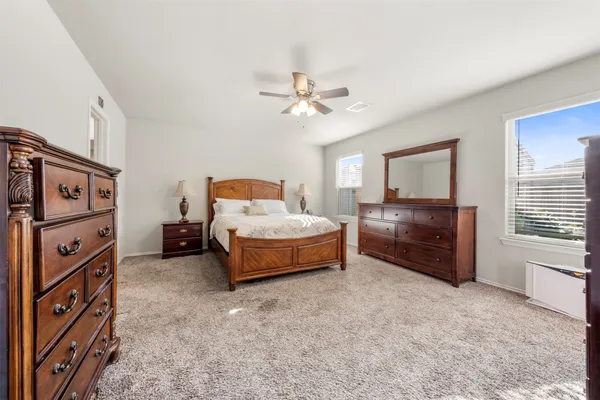a bedroom with furniture and a large window