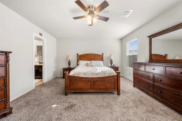 a bedroom with a bed and cabinets