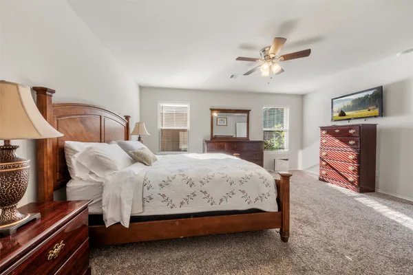 a bedroom with a bed and a chandelier