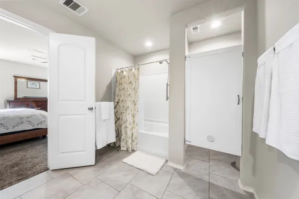 a bathroom with a shower and a tub