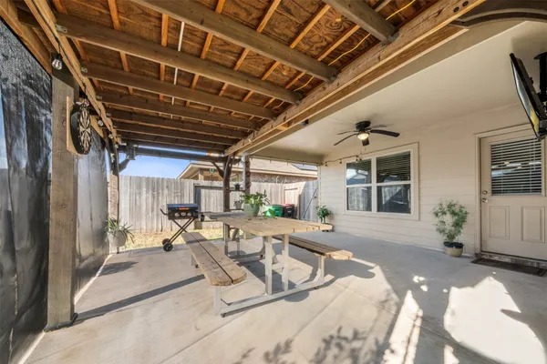 a view of a patio with table and chairs
