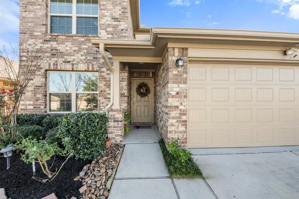 a front view of a house with plants