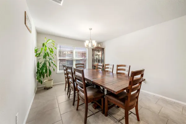 a view of a dining room with furniture and chandelier
