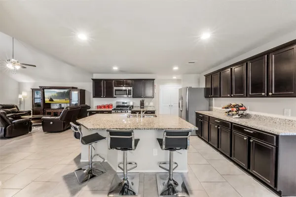 a large kitchen with a table and chairs
