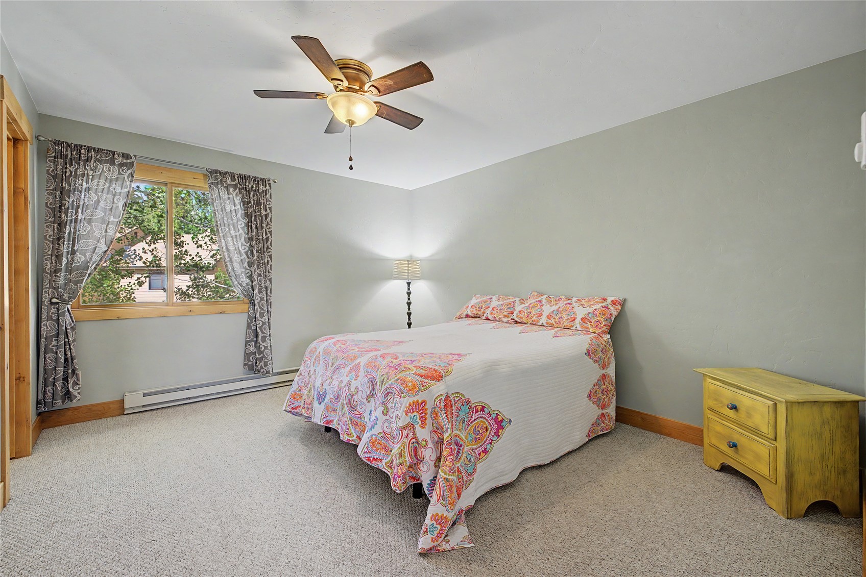 6726 Ryan Gulch Road, Unit 6726 Wildernest, CO 80498 - Photo 14 of 39 a bed sitting in a bedroom next to a window