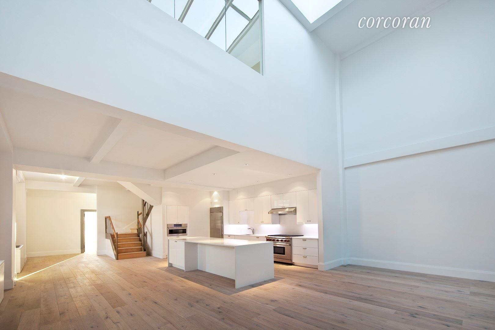 a view of kitchen with furniture and wooden floor