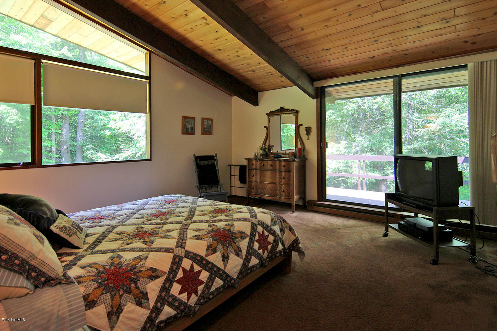 63 Monterey Road Tyringham, MA 01264 - Photo 14 of 34 a bedroom with a bed and large windows