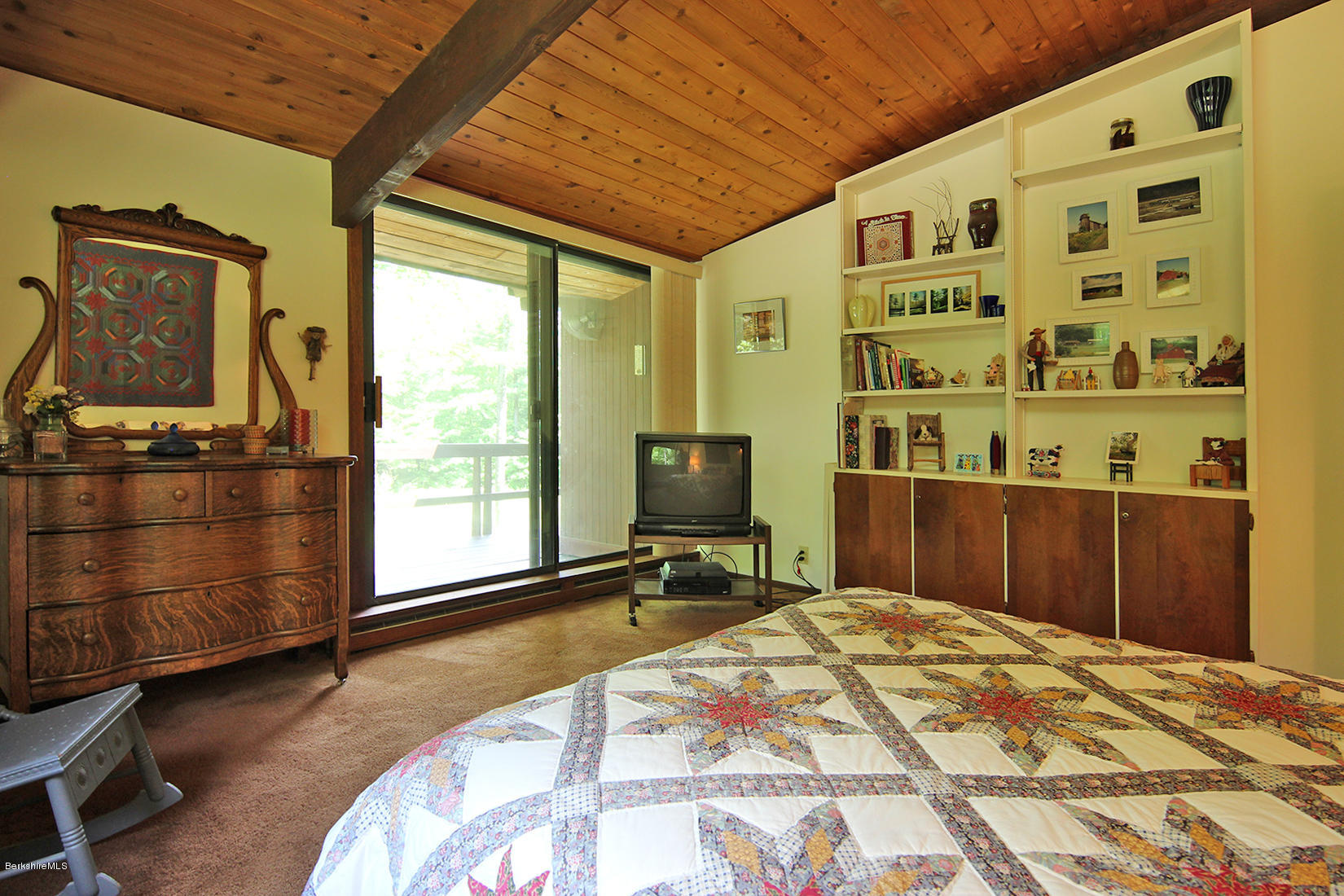 63 Monterey Road Tyringham, MA 01264 - Photo 15 of 34 a bedroom with a bed and wooden floor