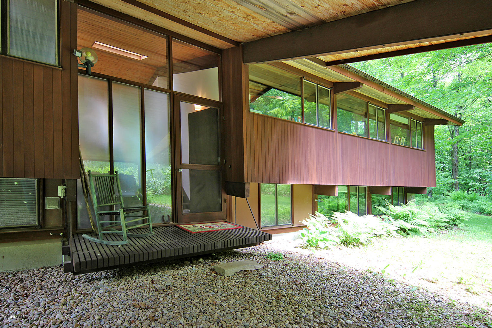 63 Monterey Road Tyringham, MA 01264 - Photo 3 of 34 a backyard of a house with a garden and outdoor seating