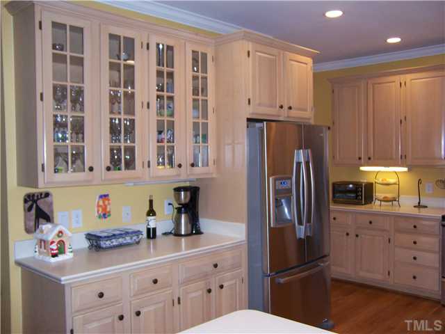 8005 Tanjier Bay Raleigh, NC 27613 - Photo 5 of 25 Glass door cabinets are a special feature in this kitchen