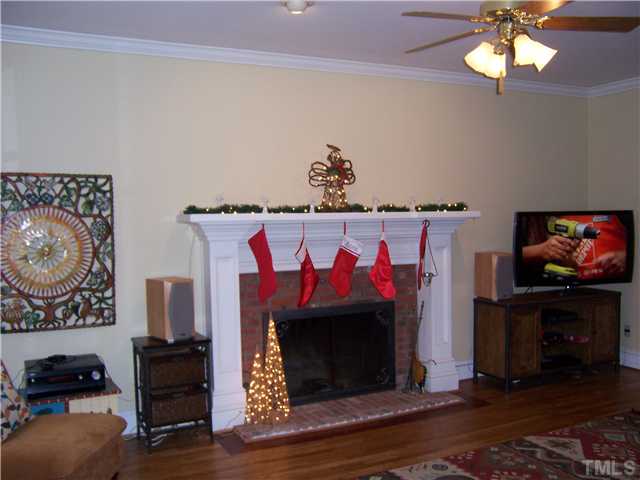 8005 Tanjier Bay Raleigh, NC 27613 - Photo 9 of 25 Freshly painted family room with wood burning fireplace