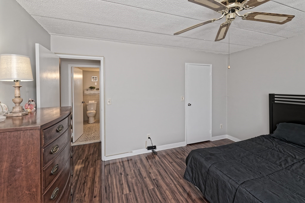 147 Turner Road, Unit 98 Holliston, MA 01746 - Photo 13 of 42 a bedroom with a bed and wooden floor