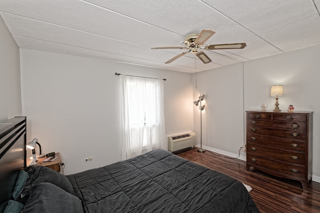 147 Turner Road, Unit 98 Holliston, MA 01746 - Photo 15 of 42 a bedroom with a bed and a chandelier