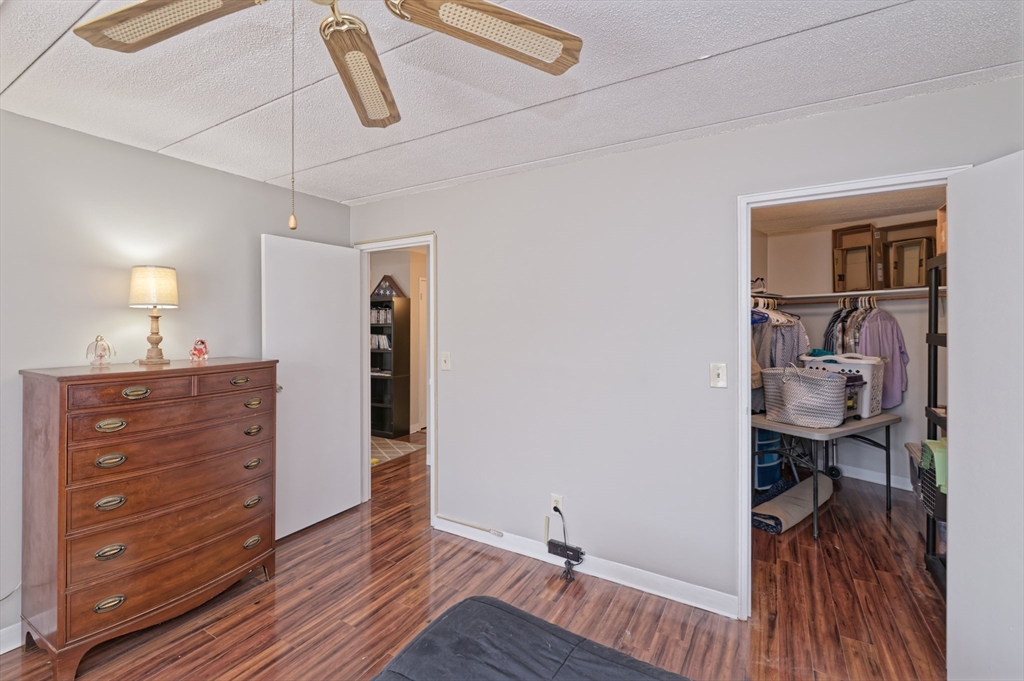 147 Turner Road, Unit 98 Holliston, MA 01746 - Photo 18 of 42 a view of walk in closet with clothes and shoes
