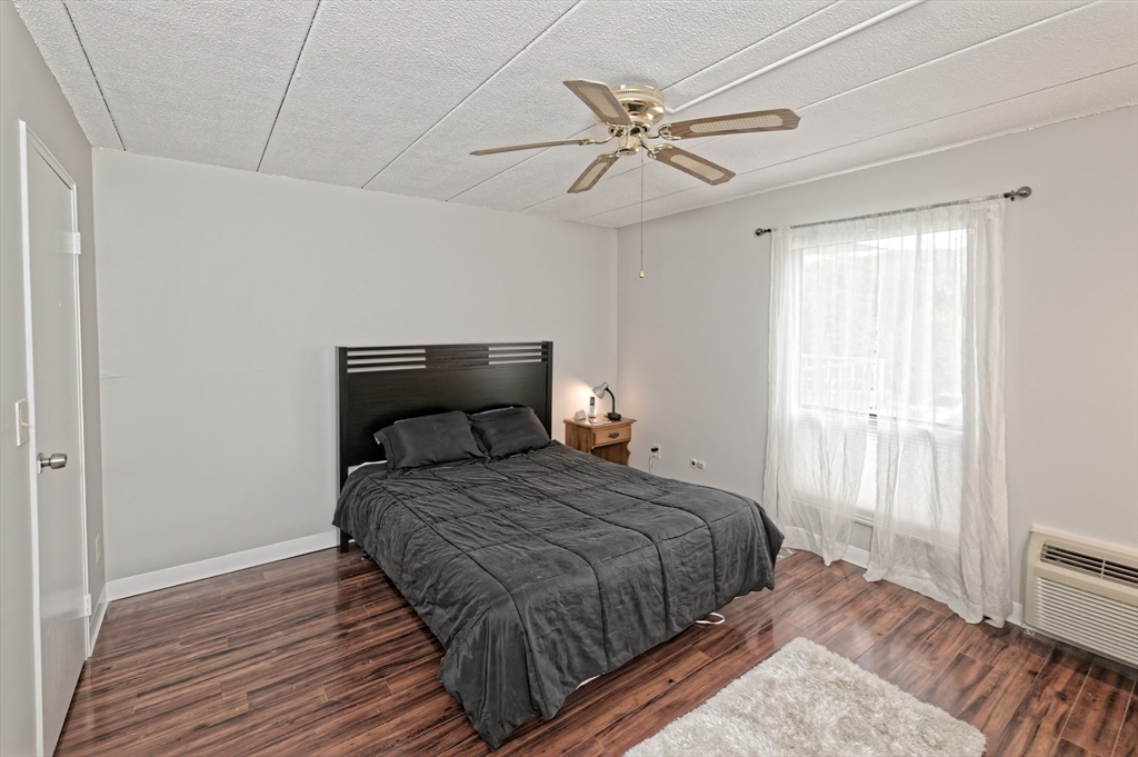 147 Turner Road, Unit 98 Holliston, MA 01746 - Photo 20 of 42 a bedroom with a bed and wooden floor
